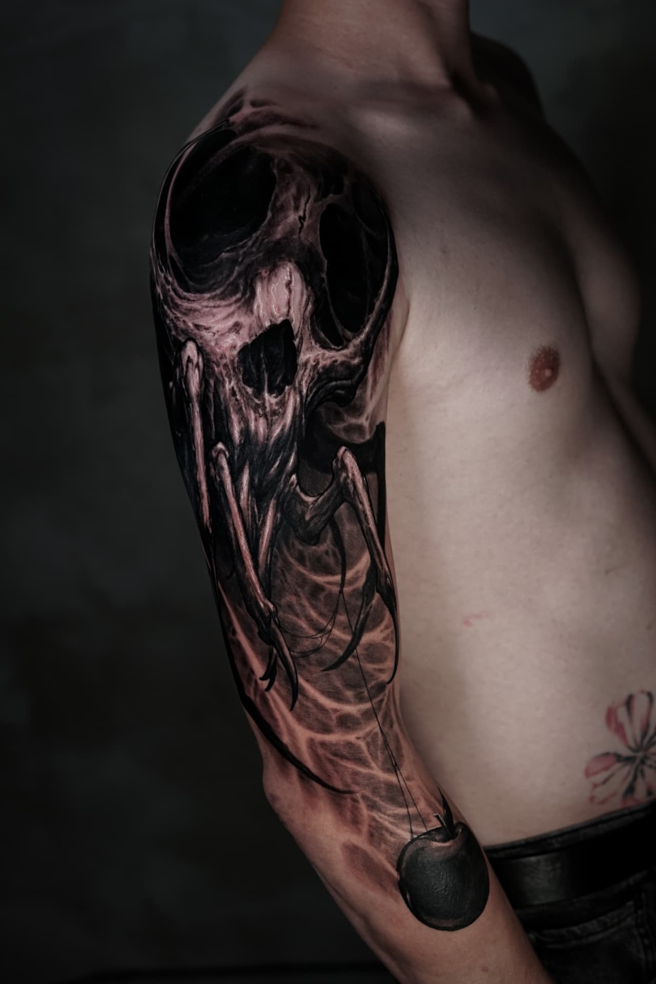 Black-and-grey skull and snake chest tattoo by Andrew Stopay