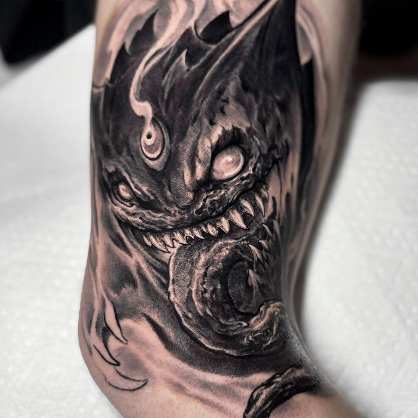 Black-and-grey demonic face tattoo by Andrew Stopay